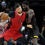 
              Portland Trail Blazers center Jusuf Nurkic is fouled by Phoenix Suns center Deandre Ayton, right, during the second half of an NBA basketball game, Friday, Nov. 4, 2022, in Phoenix. (AP Photo/Matt York)
            