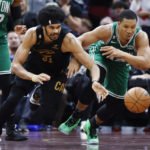 
              Cleveland Cavaliers center Jarrett Allen (31) and Boston Celtics forward Grant Williams (12) chase the ball during the second half of an NBA basketball game Wednesday, Nov. 2, 2022, in Cleveland. The Cavaliers won 114-113 in overtime. (AP Photo/Ron Schwane)
            