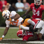 
              Tennessee running back Jaylen Wright (20) brought down by Georgia defensive lineman Mykel Williams (13) and another Georgia player during the first half of an NCAA college football game Saturday, Nov. 5, 2022 in Athens, Ga. (AP Photo/John Bazemore)
            