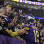 
              Minnesota Vikings wide receiver Adam Thielen (19) celebrates with fans after catching a 15-yard touchdown pass during the second half of an NFL football game against the New England Patriots, Thursday, Nov. 24, 2022, in Minneapolis. (AP Photo/Andy Clayton-King)
            