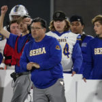 
              FILE - Junipero Serra High School coach Patrick Walsh of watches a play during the first half of the 2021 CIF Open Division high school football state championship game Saturday, Dec. 11, 2021, in Mission Viejo Calif. Walsh, says prospects at his school have become more open to considering programs from outside the West Coast. (AP Photo/Ashley Landis, File)
            