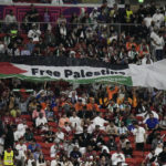 
              Supporters show a flag reading "Free Palestine" on the tribune during the World Cup group A soccer match between the Netherlands and Qatar, at the Al Bayt Stadium in Al Khor , Qatar, Tuesday, Nov. 29, 2022. (AP Photo/Moises Castillo)
            