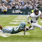 
              UCF quarterback John Rhys Plumlee (10) runs against Tulane safety Lummie Young IV (23) during an NCAA college football game in New Orleans, Saturday, Nov. 12, 2022. (AP Photo/Matthew Hinton)
            
