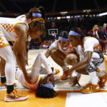 
              Tennessee guard Jordan Horston (25) is surrounded by her teammates as she lies on the floor after being injured during the first half of the team's NCAA college basketball game against Massachusetts, Thursday, Nov. 10, 2022, in Knoxville, Tenn. (AP Photo/Wade Payne)
            