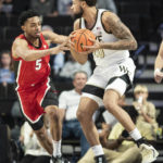 
              Georgia center Frank Anselem (5) and Wake Forest forward Davion Bradford (20) vie for the ball in the first half of an NCAA college basketball game Friday, Nov. 11, 2022, in Winston-Salem, N.C. (Allison Lee Isley/The Winston-Salem Journal via AP)
            