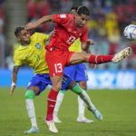 
              Switzerland's Ricardo Rodriguez, right, vies for the ball with Brazil's Raphinha during the World Cup group G soccer match between Brazil and Switzerland, at the Stadium 974 in Doha, Qatar, Monday, Nov. 28, 2022. (AP Photo/Ariel Schalit)
            