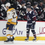 
              Colorado Avalanche right wing Logan O'Connor, right, is congratulated as he passes the team box after scoring a goal as Nashville Predators defenseman Ryan McDonagh heads back to the bench in the second period of an NHL hockey game, Thursday, Nov. 10, 2022, in Denver. (AP Photo/David Zalubowski)
            