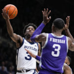 
              Butler guard Chuck Harris (3) shoots over Kansas State forward David N'Guessan (3) in the first half of an NCAA college basketball game in Indianapolis, Wednesday, Nov. 30, 2022. (AP Photo/Michael Conroy)
            