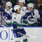 
              Vancouver Canucks defenseman Ethan Bear (74) celebrates his goal during the first period of an NHL hockey game against the Buffalo Sabres, Tuesday, Nov. 15, 2022, in Buffalo, N.Y. (AP Photo/Jeffrey T. Barnes)
            