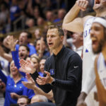 
              Duke head coach Jon Scheyer, center, claps for his team after a play in the final minutes of his first win as head coach of the Blue Devils during an NCAA college basketball game against Jacksonville in Durham, N.C., Monday, Nov. 7, 2022. (AP Photo/Ben McKeown)
            