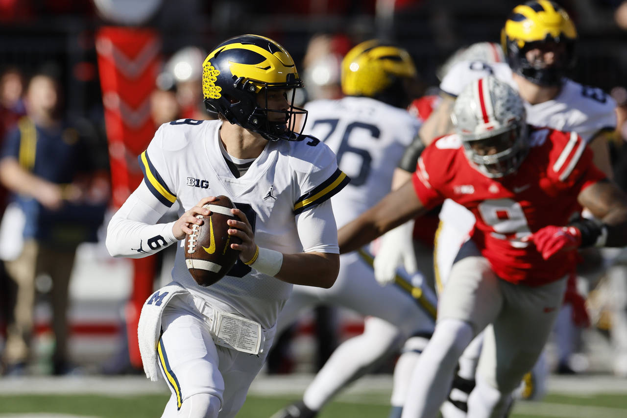 Michigan quarterback J.J. McCarthy drops back to pass against Ohio State during the first half of a...
