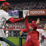 
              Philadelphia Phillies' Alec Bohm celebrates in the dugout after his home run during the second inning in Game 3 of baseball's World Series between the Houston Astros and the Philadelphia Phillies on Tuesday, Nov. 1, 2022, in Philadelphia. (AP Photo/David J. Phillip)
            