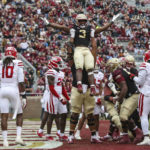 
              Florida State running back Trey Benson (3) is lifted, in celebration of his touchdown, by offensive lineman Jazston Turnetine during the third quarter of an NCAA college football game against Louisiana on Saturday, Nov. 19, 2022, in Tallahassee, Fla. (AP Photo/Gary McCullough)
            