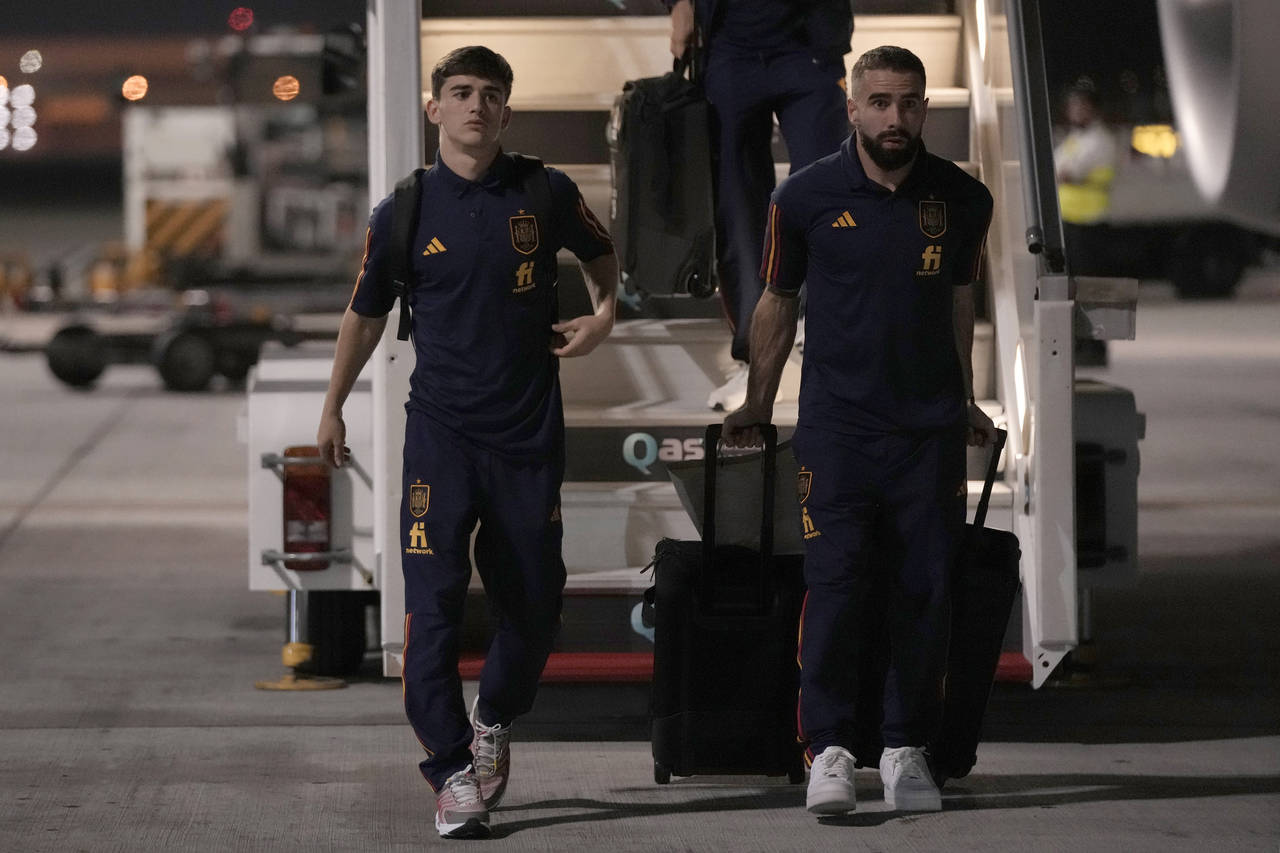 Gavi, left, and Dani Carvajal of Spain's national soccer team arrive with teammates at Hamad Intern...
