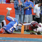 
              Florida running back Trevor Etienne (7) scores an 85-yard touchdown past South Carolina defensive back Cam Smith (9) during the first half of an NCAA college football game, Saturday, Nov. 12, 2022, in Gainesville, Fla. (AP Photo/Matt Stamey)
            