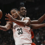 
              Brooklyn Nets' Nic Claxton (33) reaches for the ball next to Toronto Raptors' Christian Koloko during the second half of an NBA basketball game Wednesday, Nov. 23, 2022, in Toronto. (Chris Young/The Canadian Press via AP)
            