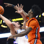 
              UCLA guard Jaime Jaquez Jr. (24) attempts a shot as Illinois guard Sencire Harris (1) defends during the second half of an NCAA college basketball game Friday, Nov. 18, 2022, in Las Vegas. (AP Photo/Chase Stevens)
            