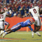 
              Florida linebacker Ventrell Miller (51) tackles South Carolina tight end Jaheim Bell (0) for a loss during the second half of an NCAA college football game, Saturday, Nov. 12, 2022, in Gainesville, Fla. (AP Photo/Matt Stamey)
            