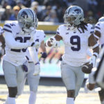 
              Kansas State safety Cincere Mason (9) and Kansas State cornerback Ekow Boye-Doe celebrate after a touchdown during the first half of an NCAA college football game against West Virginia in Morgantown, W.Va., Saturday, Nov. 19, 2022. (AP Photo/Kathleen Batten)
            
