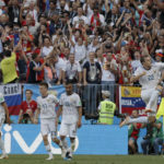 
              FILE - Russia's Artyom Dzyuba celebrates after scoring his sides 1st goal from the penalty spot during the round of 16 match between Spain and Russia at the 2018 soccer World Cup at the Luzhniki Stadium in Moscow, Russia, Sunday, July 1, 2018. Russia hosted the World Cup party in 2018 but now it's off the guest list.(AP Photo/Manu Fernandez, File)
            