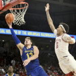 
              South Dakota State forward Luke Appel (13) tries to drive past Arkansas forward Jalen Graham (11) during the first half of an NCAA college basketball game Wednesday, Nov. 16, 2022, in Fayetteville, Ark. (AP Photo/Michael Woods)
            