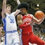 
              Ohio State's Justice Sueing (14) looks to pass as Duke's Kyle Filipowski (30) defends during the first half of an NCAA college basketball game in Durham, N.C., Wednesday, Nov. 30, 2022. (AP Photo/Ben McKeown)
            