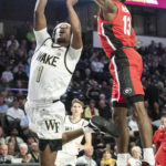 
              Georgia guard Mardrez McBride (13) blocks a shot by Wake Forest guard Tyree Appleby (1) in the first half of an NCAA college basketball game Friday, Nov. 11, 2022, in Winston-Salem, N.C. (Allison Lee Isley/The Winston-Salem Journal via AP)
            