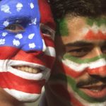 
              FILE - Mike Moscrop, left, from Orange County, Calif., poses with Amir Sieidoust, an Iranian supporter living in Holland outside the Gerlain Stadium in Lyon, June 21, 1998, before the start of the USA vs Iran World Cup soccer match. Iran defeated the U.S. 2-1 for its first World Cup win, eliminating them after just two games. A rematch between the U.S. and Iran will be played, Tuesday, Nov. 29, 2022. (AP Photo/Jerome Delay)
            