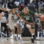 
              Miami guard Isaiah Wong (2) steals the ball from Providence guard Noah Locke (10) in the second half of an NCAA college basketball game, Saturday, Nov. 19, 2022, in Uncasville, Conn. (AP Photo/Jessica Hill)
            