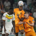 
              Denzel Dumfries of the Netherlands, center, jumps for a header with Senegal's Ismaila Sarr, left and Matthijs de Ligt of the Netherlands during the World Cup, group A soccer match between Senegal and Netherlands at the Al Thumama Stadium in Doha, Qatar, Monday, Nov. 21, 2022. (AP Photo/Ricardo Mazalan)
            