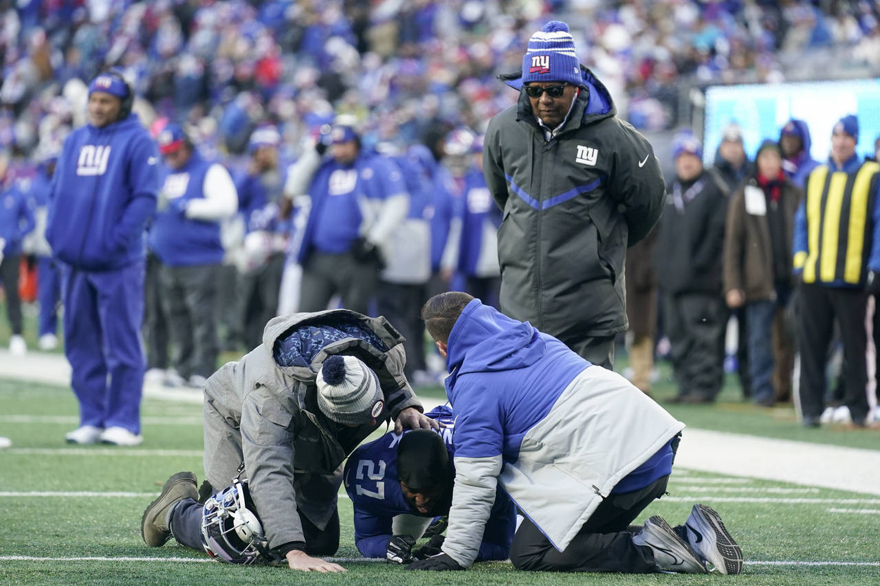 New York Giants cornerback Jason Pinnock (27) kneels on the field after an apparent injury during t...