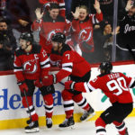 
              New Jersey Devils Nico Hischier (13) reacts with Dougie Hamilton (7) and Tomas Tatar (90) after scoring a goal against the Calgary Flames during the third period of an NHL hockey game, Tuesday, Nov. 8, 2022, in Newark, N.J. The New Jersey Devils won 3-2. (AP Photo/Noah K. Murray)
            