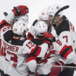 
              New Jersey Devils' Jack Hughes (86) celebrates with teammates after scoring against the Montreal Canadiens during the second period of an NHL hockey game, Tuesday, Nov. 15, 2022 in Montreal. (Graham Hughes/The Canadian Press via AP)
            