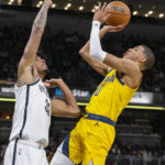 
              Indiana Pacers guard Tyrese Haliburton (0) shoots over the defense of Brooklyn Nets forward Nic Claxton (33) during the second half of an NBA basketball game in Indianapolis, Friday, Nov. 25, 2022. (AP Photo/Doug McSchooler)
            