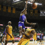 
              McNeese State forward Christian Shumate (24) dunks over Baylor guard Adam Flagler in the first half of an NCAA college basketball game, Wednesday, Nov. 23, 2022, in Waco, Texas. (AP Photo/Rod Aydelotte)
            