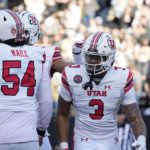
              Utah quarterback Ja'Quinden Jackson, right, is congratulated by offensive lineman Paul Maile after running for a touchdown in the first half of an NCAA college football game against Colorado, Saturday, Nov. 26, 2022, in Boulder, Colo. (AP Photo/David Zalubowski)
            