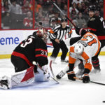 
              Ottawa Senators goaltender Cam Talbot (33) watches the rebound as defenseman Nick Holden (5) forces Philadelphia Flyers center Kevin Hayes (13) out of position during the first period of an NHL hockey game, Saturday, Nov. 5, 2022 in Ottawa, Ontario. (Justin Tang/The Canadian Press via AP)
            