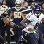 
              Baltimore Ravens quarterback Lamar Jackson (8) scrambles away from the New Orleans Saints defense in the second half of an NFL football game in New Orleans, Monday, Nov. 7, 2022. (AP Photo/Butch Dill)
            