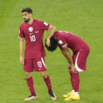 
              FILE - Qatar's Hassan Al-Haydos, left, and Akram Afif reacts after the World Cup group A soccer match between Qatar and Senegal, at the Al Thumama Stadium in Doha, Qatar, Friday, Nov. 25, 2022. Senegal won 3-1. Qatar became the first host nation in World Cup history to lose the opening match, and then only the second host to be eliminated from the group stage. South Africa in 2010 was the first host nation to be eliminated in group stage but still had a chance to advance in its third and final group match. (AP Photo/Ariel Schalit, File)
            