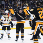 
              Pittsburgh Penguins' Josh Archibald, center, celebrates after scoring against the Boston Bruins during the second period of an NHL hockey game Tuesday, Nov. 1, 2022, in Pittsburgh. (AP Photo/Keith Srakocic)
            