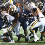 
              Tennessee running back Jabari Small (2) crosses the goal line for a touchdown as he's hit by Vanderbilt defensive lineman Devin Lee (99) during the first half of an NCAA college football game Saturday, Nov. 26, 2022, in Nashville, Tenn. (AP Photo/Wade Payne)
            
