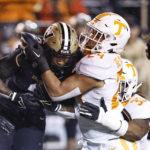 
              Vanderbilt running back Ray Davis (2) is tackled by Tennessee linebackers Aaron Beasley (24), and Jeremy Banks (33) during the first half of an NCAA college football game Saturday, Nov. 26, 2022, in Nashville, Tenn. (AP Photo/Wade Payne)
            