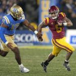 
              Southern California running back Austin Jones, right, runs the ball as UCLA defensive lineman Grayson Murphy gives chase during the second half of an NCAA college football game Saturday, Nov. 19, 2022, in Pasadena, Calif. (AP Photo/Mark J. Terrill)
            