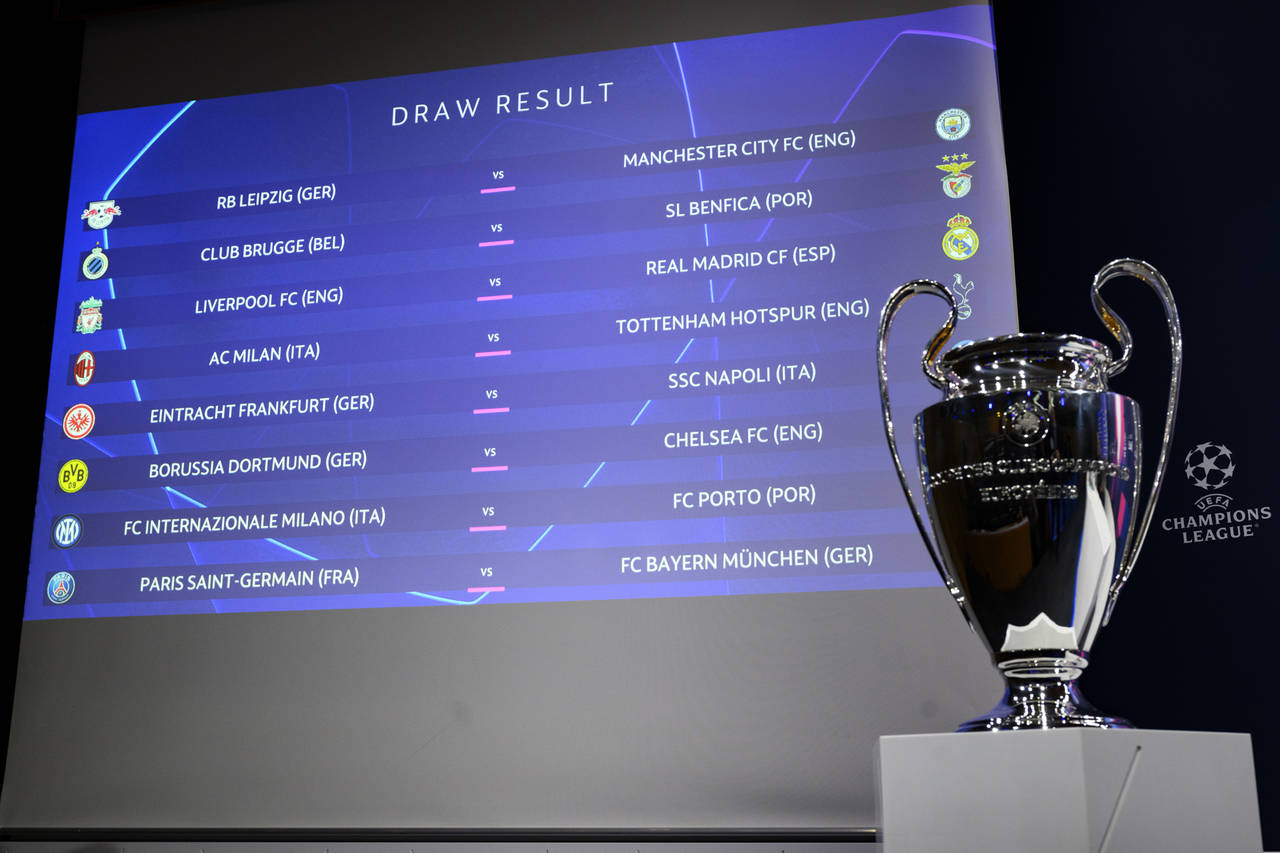 The match fixtures are shown on an electronic panel next to the Champions League trophy during the ...