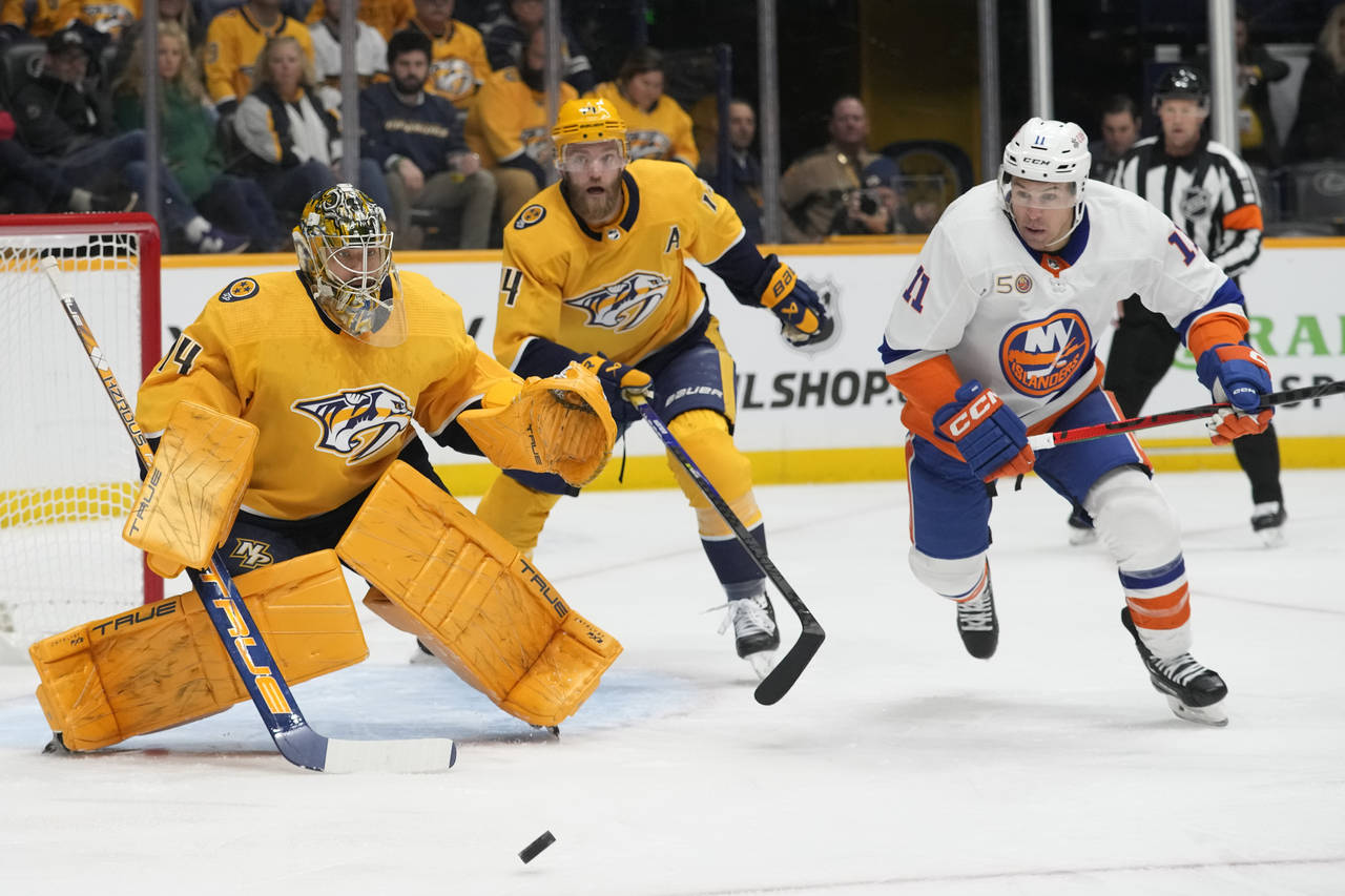 New York Islanders' Zach Parise (11) chases the puck after Nashville Predators goaltender Juuse Sar...