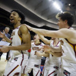 
              FILE - Loyola's (La.) Zach Wrightsil, left, is congratulated by his teammates after winning the NAIA Player of the Year award as they celebrate their 71-56 win over Talladega in the national championship college basketball game, Tuesday, March 22, 2022, in Kansas City, Mo. They already overcame the ravages of a hurricane to win a national title at their old school. Now former Loyola-New Orleans teammates Zach Wrightsil, Myles Burns and Brandon Davis are aiming for one more improbable achievement as they attempt to make the leap from their NAIA program and succeed at the NCAA Division I level. (AP Photo/Colin E. Braley, File)
            