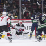 
              Vancouver Canucks' Bo Horvat (53) scores against New Jersey Devils goalie MacKenzie Blackwood (29) during the third period of an NHL hockey game Tuesday, Nov. 1, 2022, in Vancouver, British Columbia. (Darryl Dyck/The Canadian Press via AP)
            
