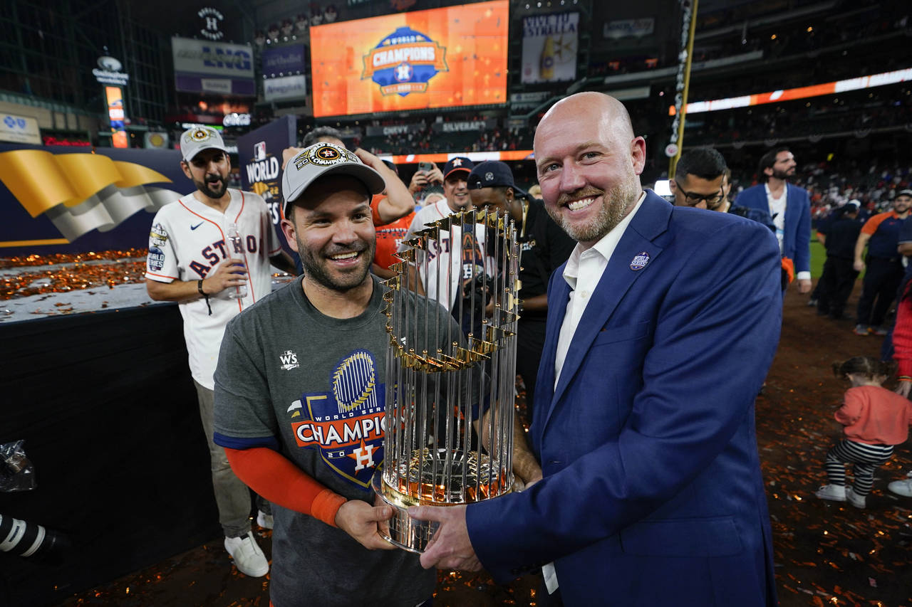 Houston Astros second baseman Jose Altuve and general manager James click celebrate with the trophy...
