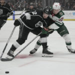 
              Minnesota Wild center Marco Rossi (23) and Los Angeles Kings left wing Kevin Fiala (22) reach for the puck during the first period of an NHL hockey game Tuesday, Nov. 8, 2022, in Los Angeles. (AP Photo/Ashley Landis)
            