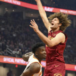 
              Cleveland Cavaliers center Robin Lopez, right, shoots against Atlanta Hawks center Clint Capela, left, during the first half of an NBA basketball game, Monday, Nov. 21, 2022, in Cleveland. (AP Photo/Nick Cammett)
            